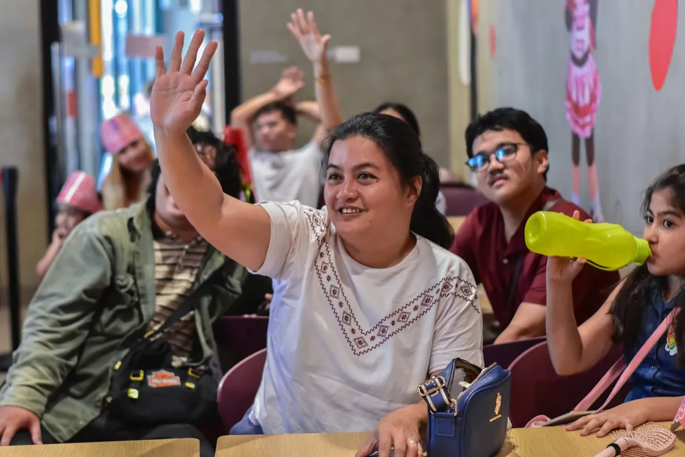 Guest waving cheerfully during a birthday party in Imus, Cavite