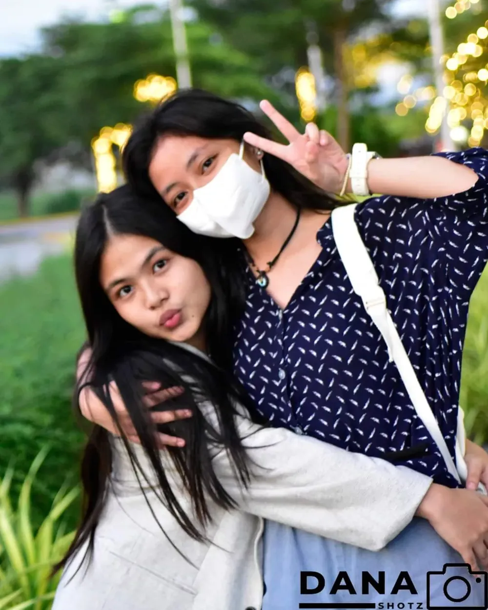Two friends posing in a park, outdoor portrait by Dana Shotz in Cavite